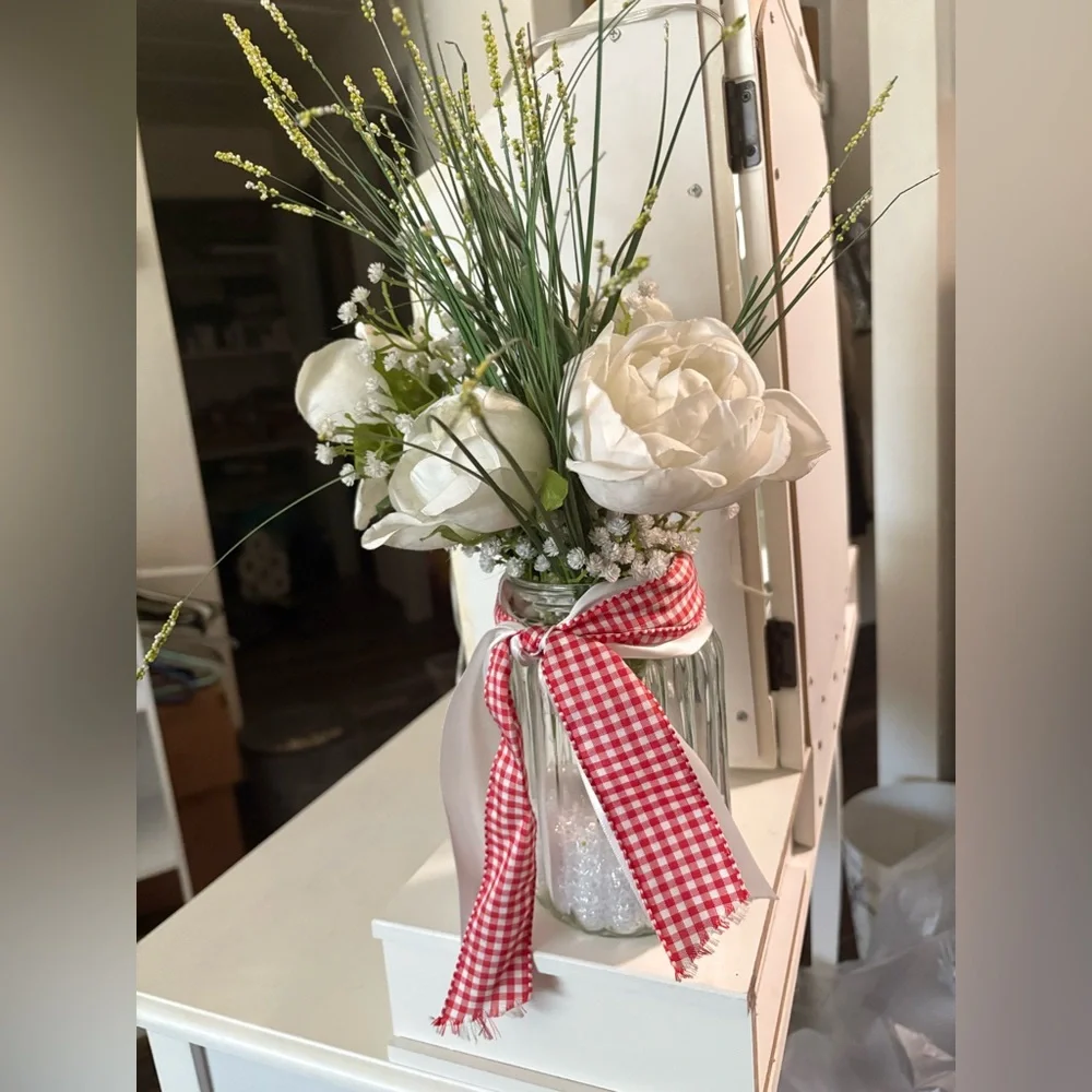 White Floral Arrangement in Glass Jar with Red & White Ribbon